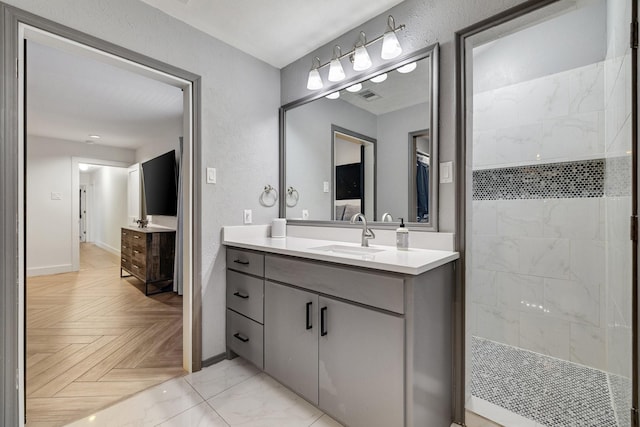 bathroom featuring vanity and a tile shower