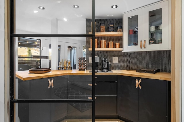 bar featuring white cabinets, butcher block counters, and tasteful backsplash