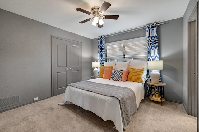 bedroom featuring ceiling fan, a closet, and carpet flooring