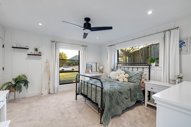 bedroom with ceiling fan, ornamental molding, and light colored carpet