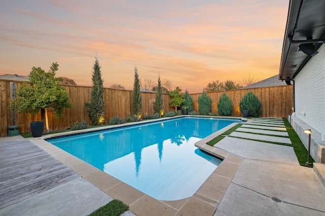 view of pool at dusk