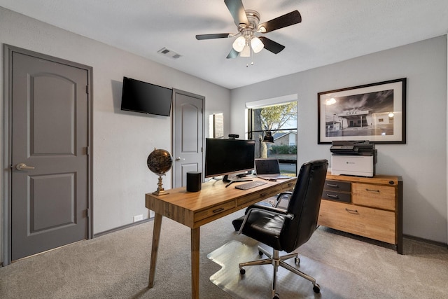 home office featuring light carpet and ceiling fan