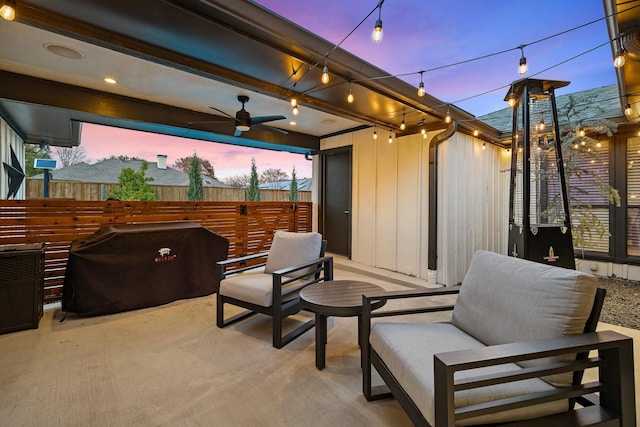 patio terrace at dusk with ceiling fan and grilling area