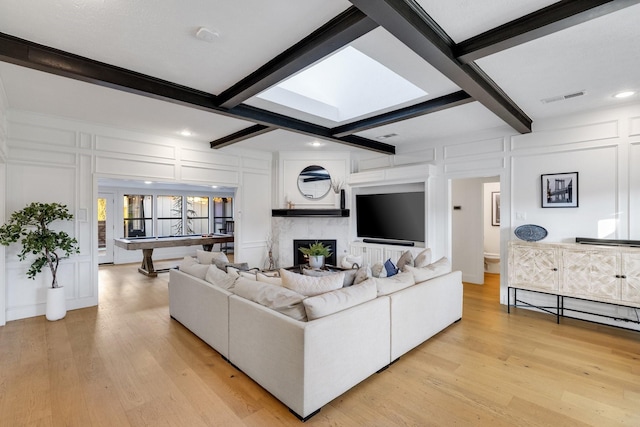 living room featuring billiards, light hardwood / wood-style floors, and beamed ceiling