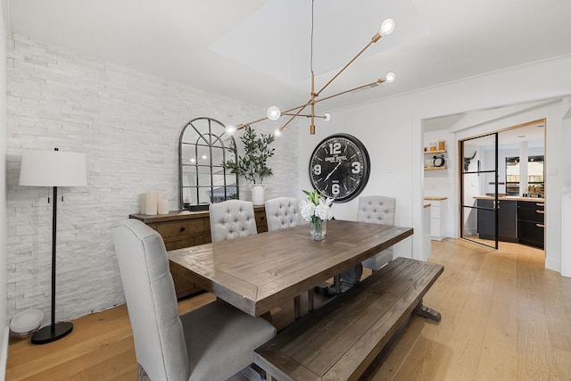 dining room with a chandelier and light hardwood / wood-style flooring