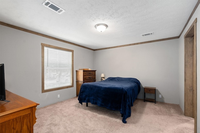 carpeted bedroom with a textured ceiling and ornamental molding