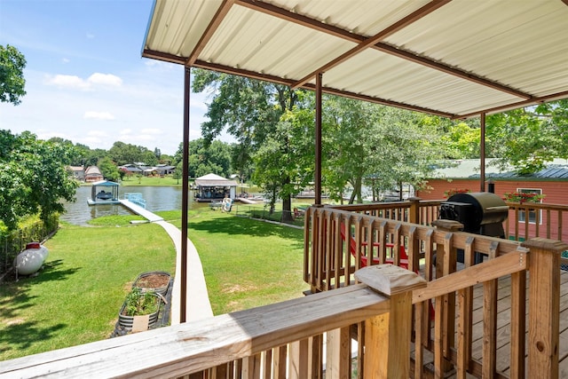 wooden terrace with a lawn, a water view, and grilling area