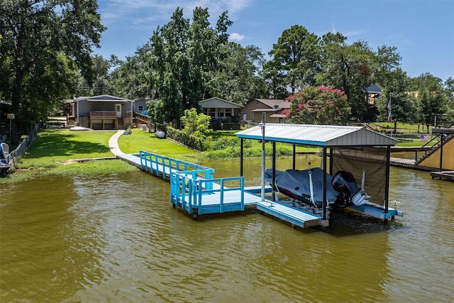 dock area with a lawn and a water view