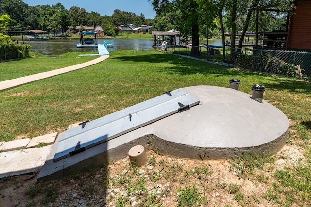 view of storm shelter featuring a water view and a yard