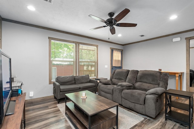 living room featuring ceiling fan, crown molding, and dark wood-type flooring