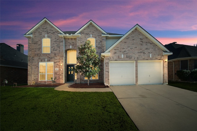 view of front property featuring a garage and a lawn