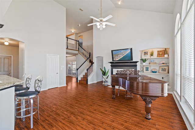 interior space featuring ceiling fan, plenty of natural light, high vaulted ceiling, and dark hardwood / wood-style floors