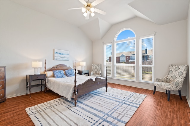 bedroom with ceiling fan, wood-type flooring, and lofted ceiling