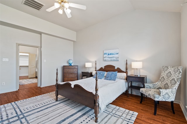 bedroom with a walk in closet, ceiling fan, hardwood / wood-style floors, and vaulted ceiling