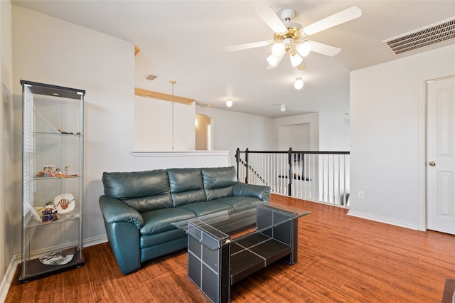 living room with dark hardwood / wood-style floors and ceiling fan