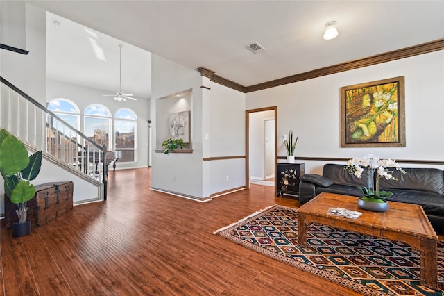 living room featuring hardwood / wood-style flooring, ceiling fan, and crown molding