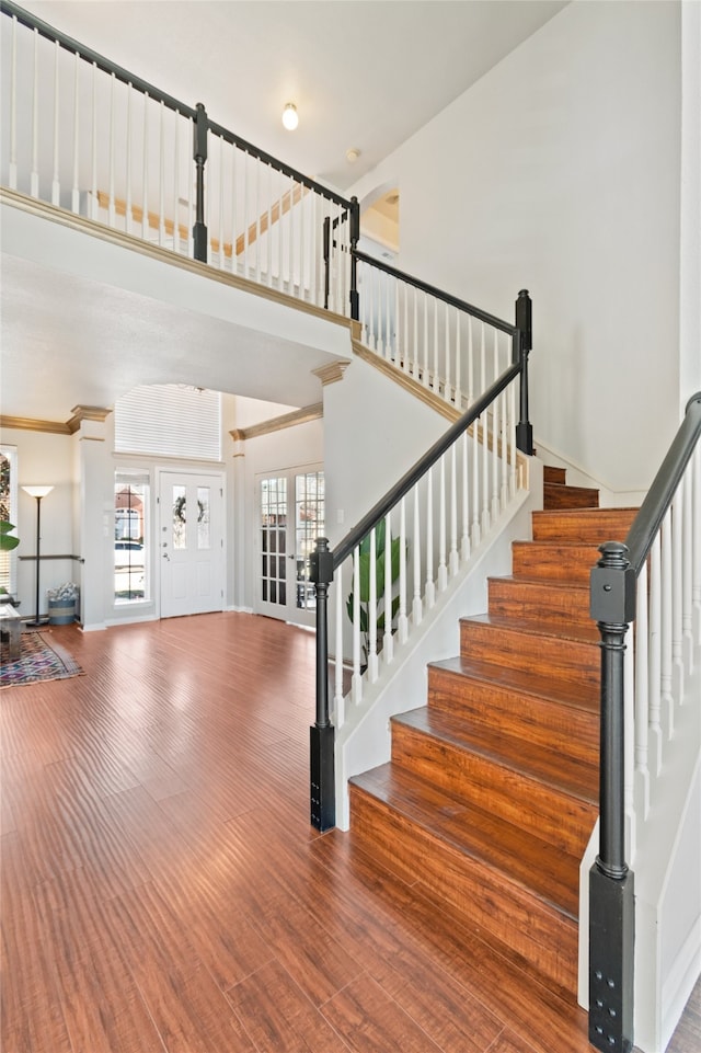 staircase featuring french doors and wood-type flooring