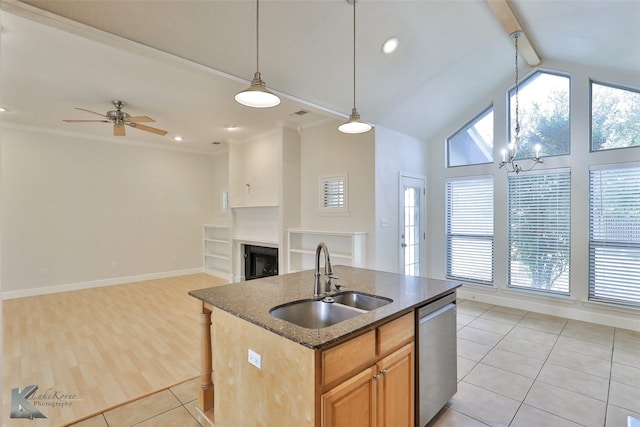 kitchen with sink, hanging light fixtures, stainless steel dishwasher, light tile patterned floors, and ceiling fan with notable chandelier