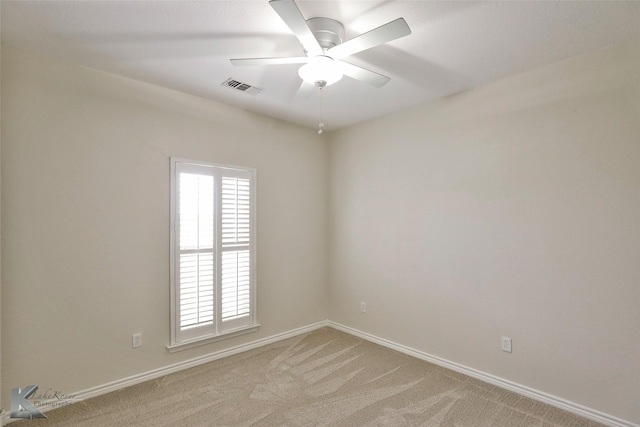 empty room with ceiling fan and light colored carpet