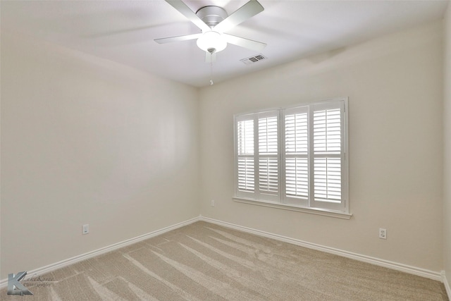 carpeted spare room with ceiling fan