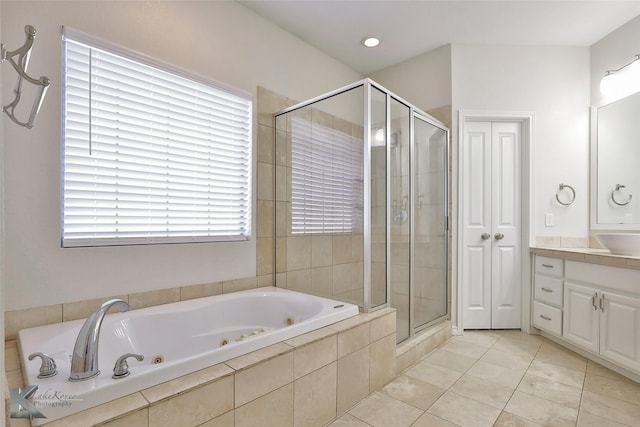 bathroom with tile patterned flooring, vanity, and independent shower and bath