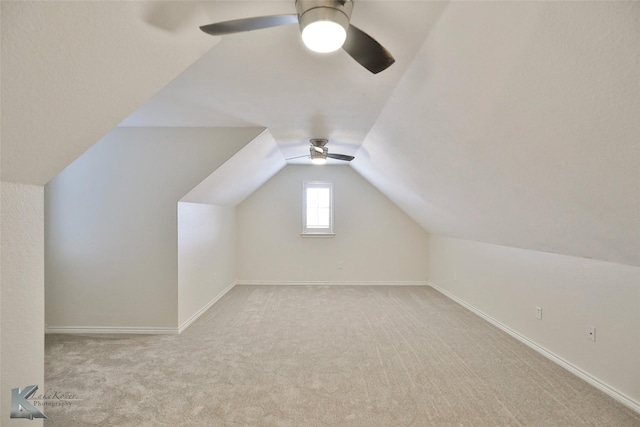 bonus room featuring ceiling fan, lofted ceiling, and light carpet