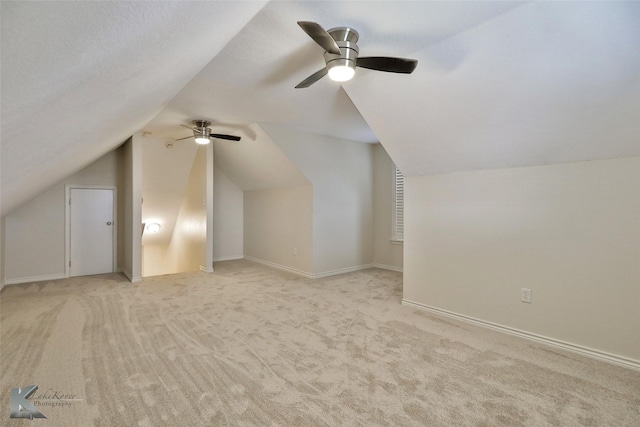 additional living space featuring ceiling fan, light carpet, and lofted ceiling