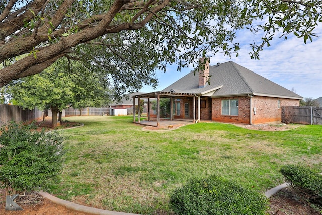 back of house featuring a yard and a patio