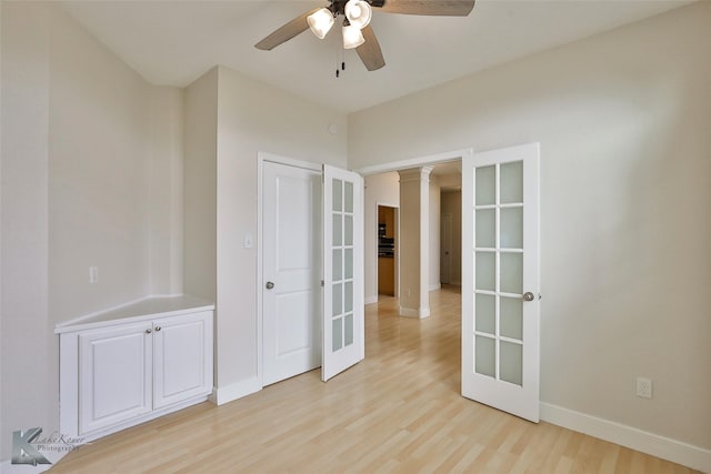 unfurnished room with ceiling fan, french doors, and light wood-type flooring