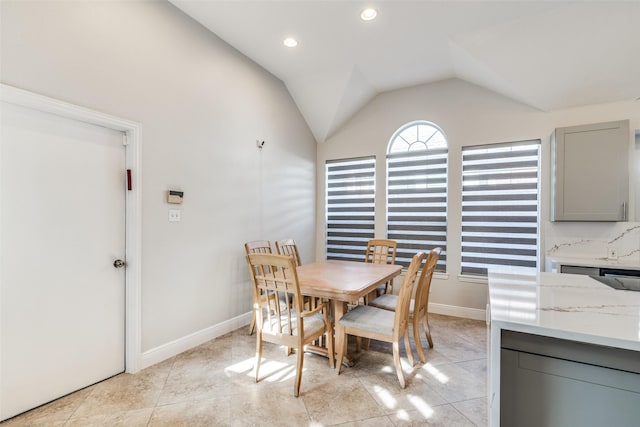 tiled dining area with lofted ceiling