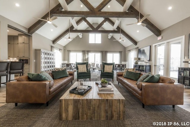 living room with beamed ceiling, wood-type flooring, and high vaulted ceiling