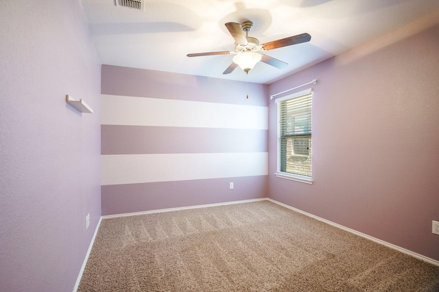 spare room featuring carpet flooring and ceiling fan