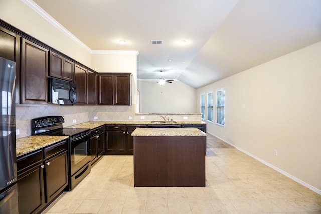 kitchen featuring backsplash, light stone counters, vaulted ceiling, black appliances, and a center island