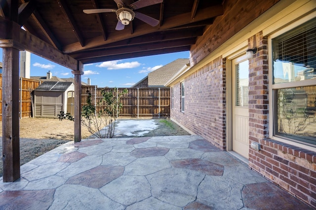 view of patio / terrace with ceiling fan and a shed