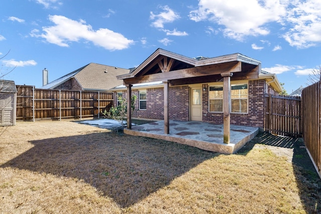 back of house with a patio and a lawn