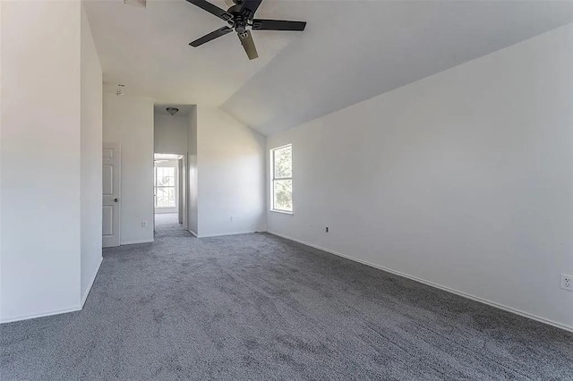 spare room with carpet flooring, vaulted ceiling, and ceiling fan