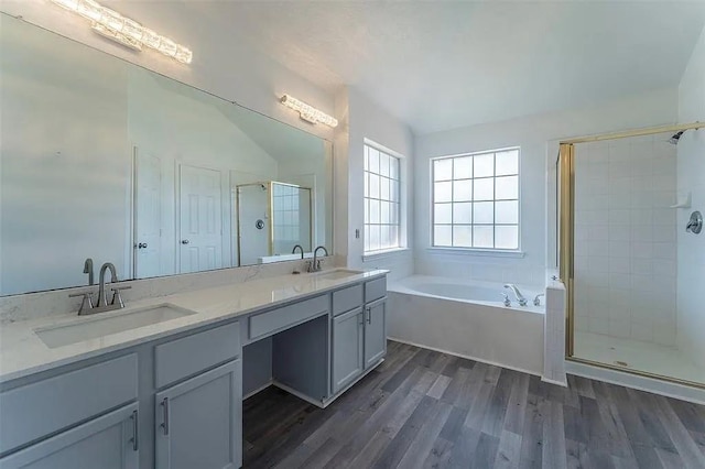 bathroom featuring shower with separate bathtub, vanity, and hardwood / wood-style floors