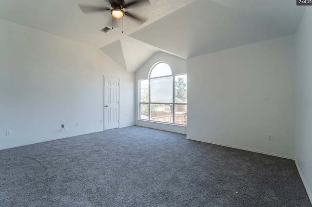 unfurnished room with ceiling fan, dark carpet, and vaulted ceiling