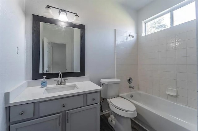 full bathroom featuring vanity, toilet, and tiled shower / bath