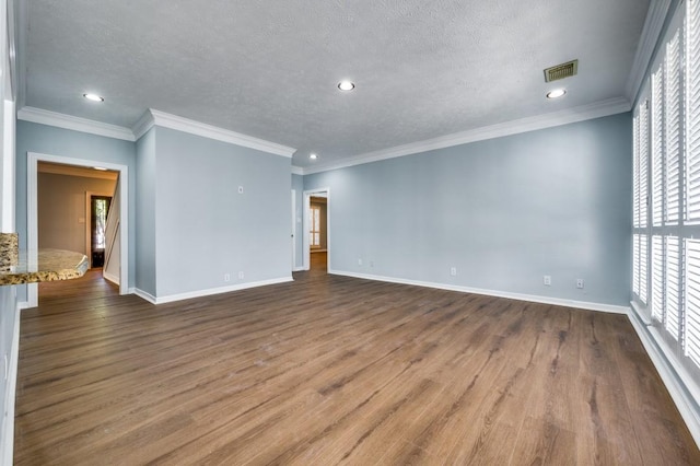 unfurnished room with hardwood / wood-style flooring, crown molding, and a textured ceiling