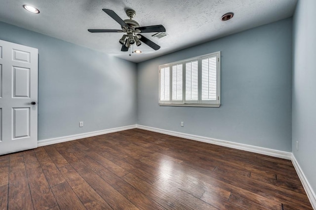 empty room featuring a textured ceiling, dark hardwood / wood-style flooring, and ceiling fan