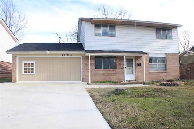 view of front property featuring a garage and a front lawn