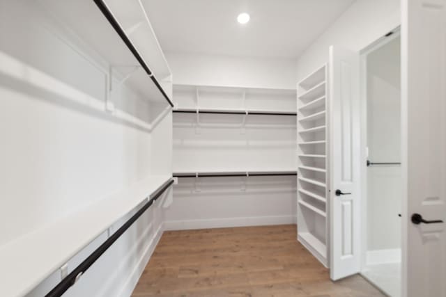 spacious closet with light hardwood / wood-style flooring