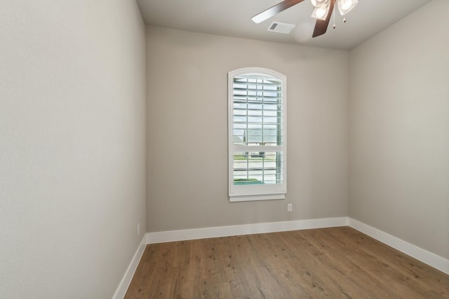 unfurnished room with hardwood / wood-style flooring, ceiling fan, and a wealth of natural light