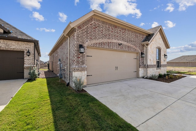 view of side of home with a garage and a lawn