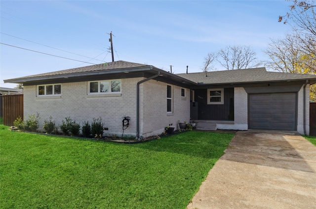 ranch-style home with a garage and a front lawn