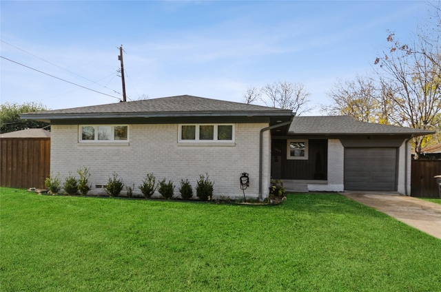 ranch-style house featuring a garage and a front lawn