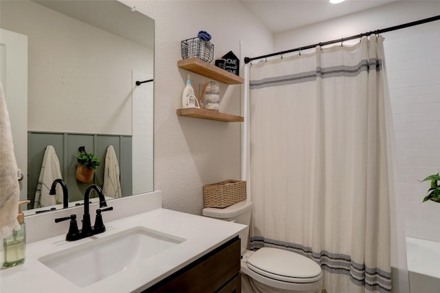 full bathroom featuring vanity, shower / bath combo, and toilet