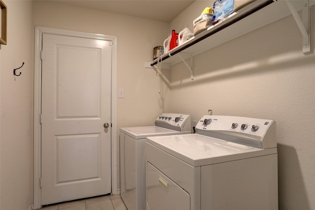 washroom featuring washer and dryer and light tile patterned floors