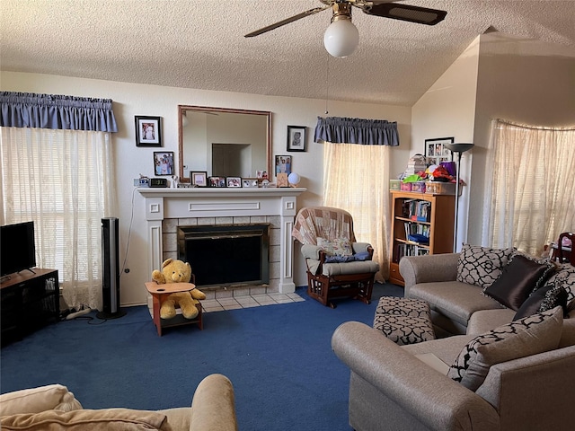 carpeted living room featuring a textured ceiling, ceiling fan, vaulted ceiling, and a fireplace